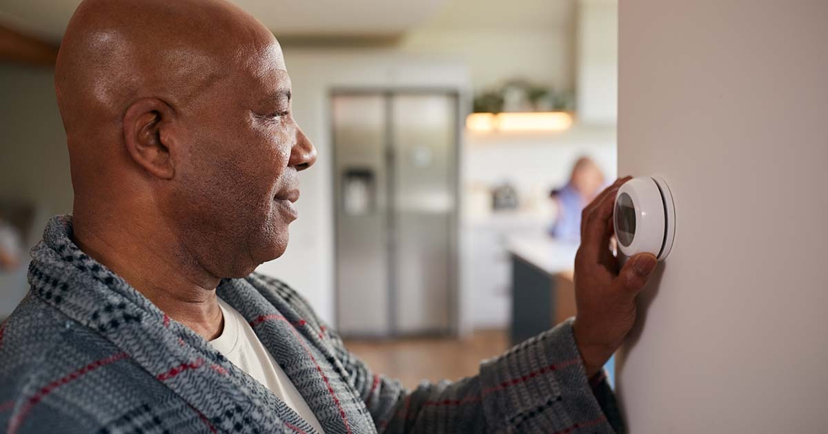 South Shore, MA Man Controlling Digital Heating Thermostat